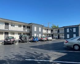 MedStay OKC, a two-story apartment building with on-site parking under a clear Oklahoma sky.